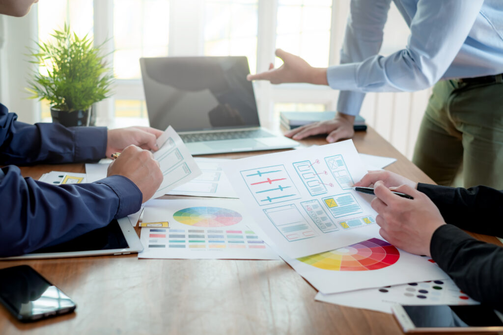 A team actively working on digital design projects, including website layout and graphic elements, showcasing their technical skills, creativity, and collaboration directly for a portfolio.