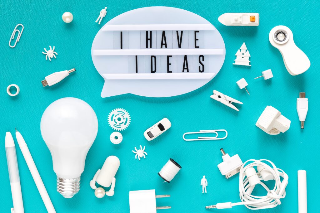 A flat-lay image featuring a glowing lightbulb, creative tools, and a speech bubble displaying “I HAVE IDEAS” — symbolizing natural skills like creativity, quick thinking, and innovation that are essential career skills employers value today.
