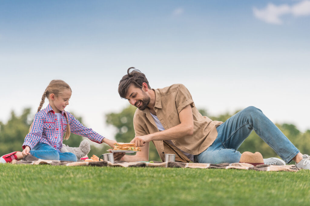 Man playing with his daughter, showing the balance between earning money and enjoying life