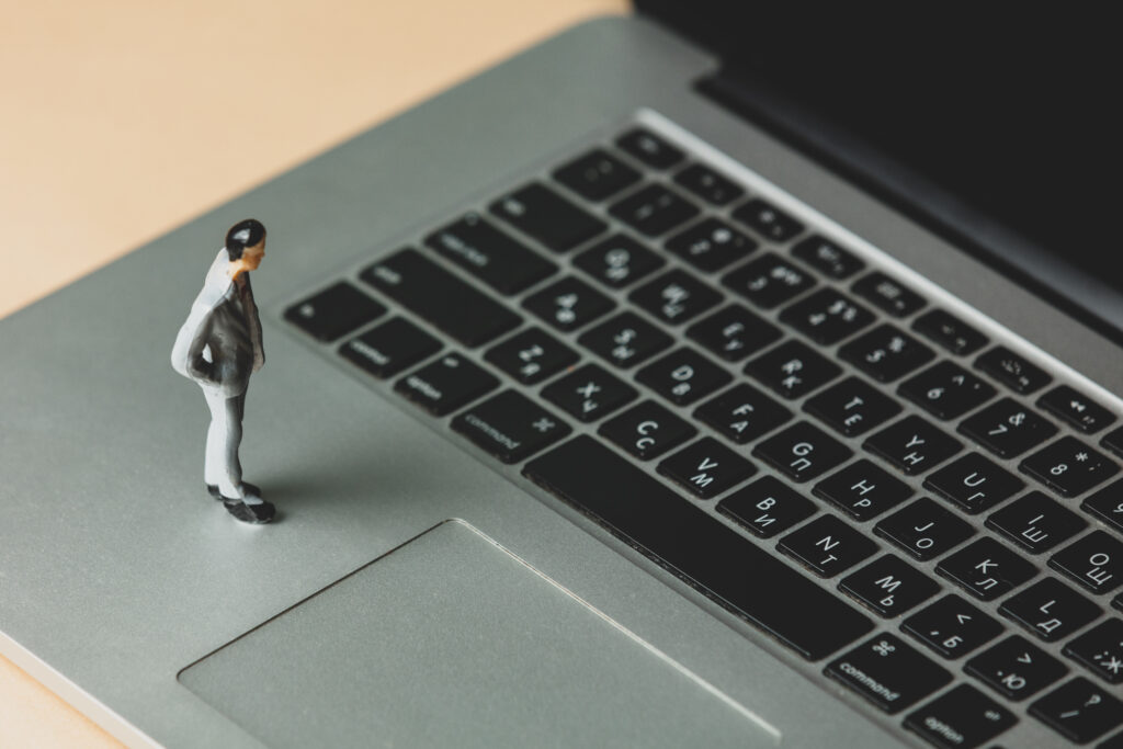 Man working from home as a data entry operator on laptop.