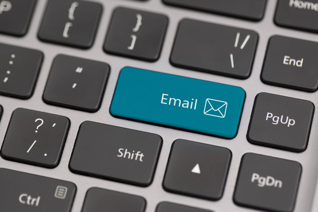 Email icon on laptop keyboard representing working from home as a support agent.