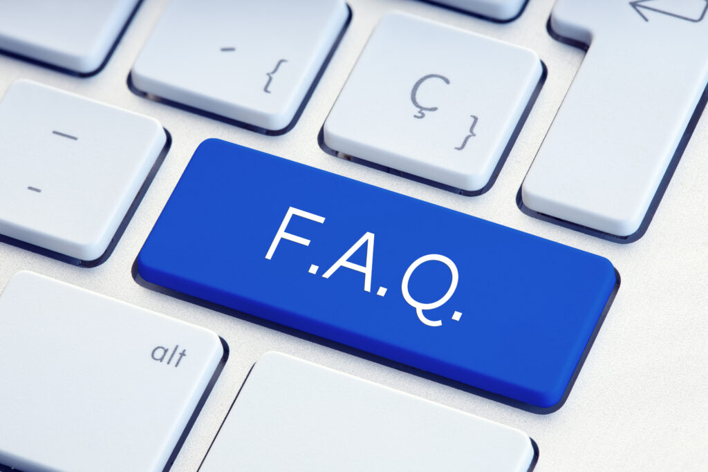 FAQ icon on laptop keyboard representing work from home job queries and answers.