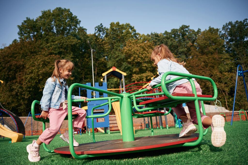 Kids playing in a park, enjoying outdoor activities that promote physical health, social skills, and healthy childhood habits.