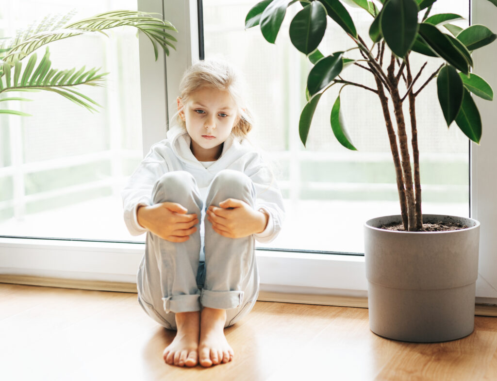 Lonely girl sitting alone as her parents are busy chasing money
