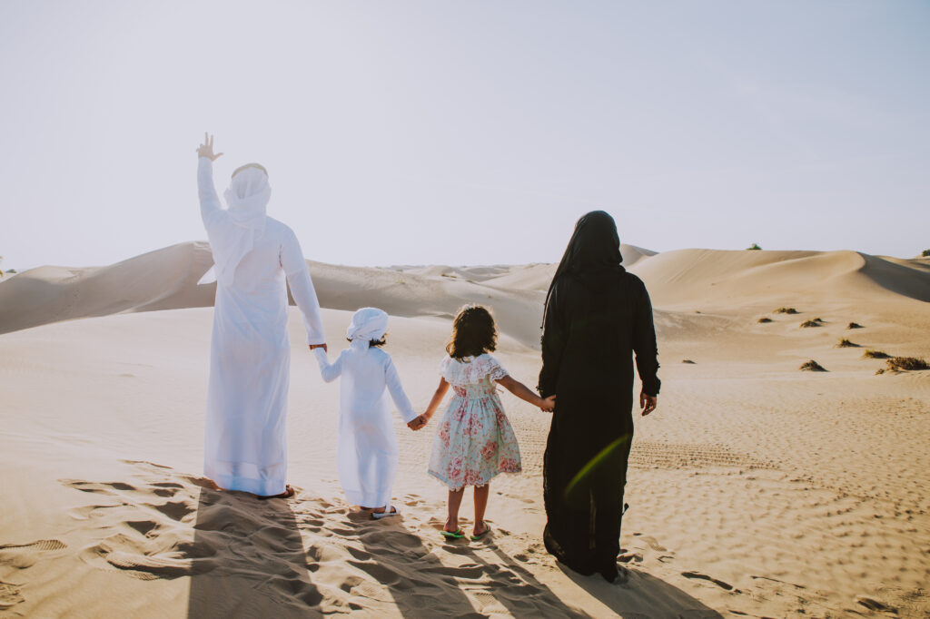 Saudi family with a child enjoying the desert in Saudi Arabia