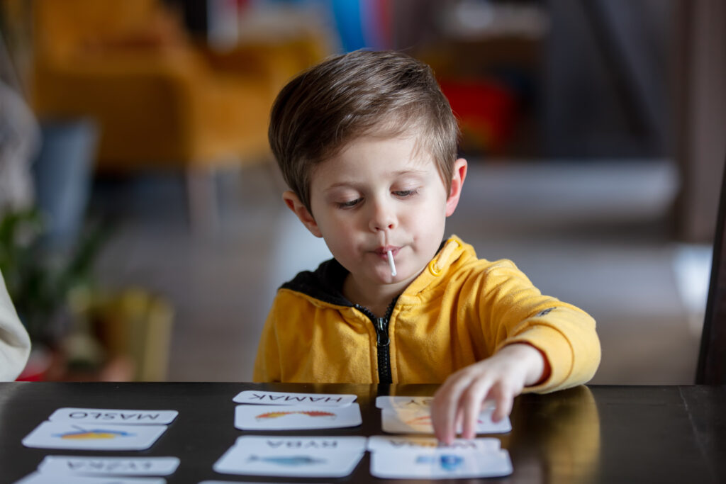 A child learning English from visuals, following easy steps to teach kids English effectively.
