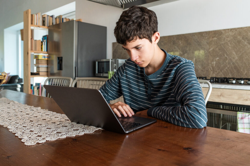 Student working from home on laptop.