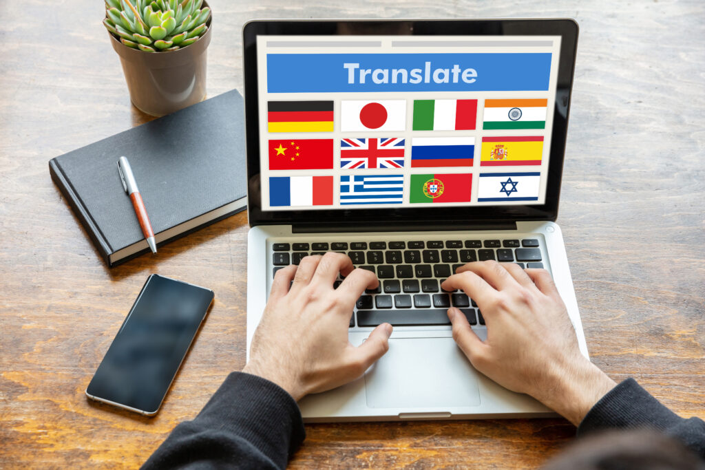 Person working from home translating text with different country maps on laptop screen.
