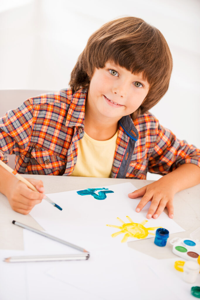 Young boy pointing at something with curiosity, representing learning or discovery.